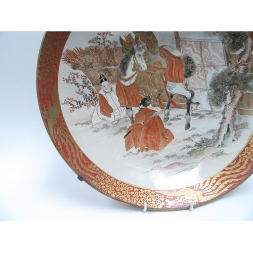 6251 - A 19th Century Japanese Kutani large Oriental shallow form dish depicting gentleman on horse playing... 