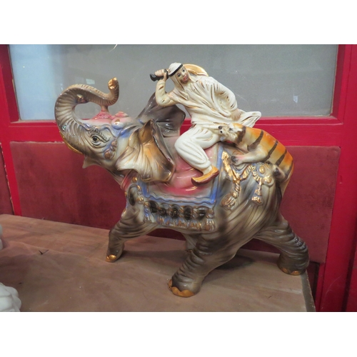 4011 - A large ceramic Capodimonte elephant and tiger figural group, marked, 38cm tall