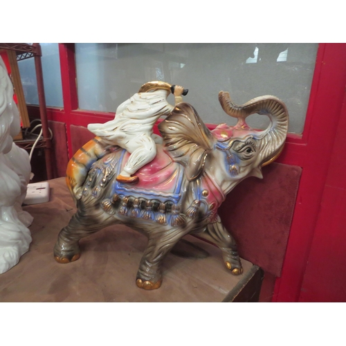 4011 - A large ceramic Capodimonte elephant and tiger figural group, marked, 38cm tall