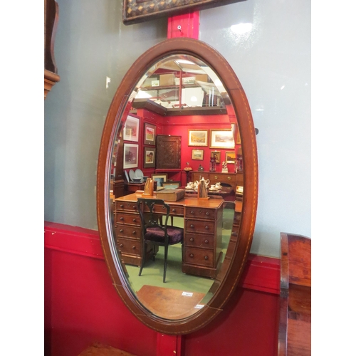 4017 - An oval wall mirror, mahogany string inlaid frame, bevel edged, loose part to frame, 70cm x 40cm