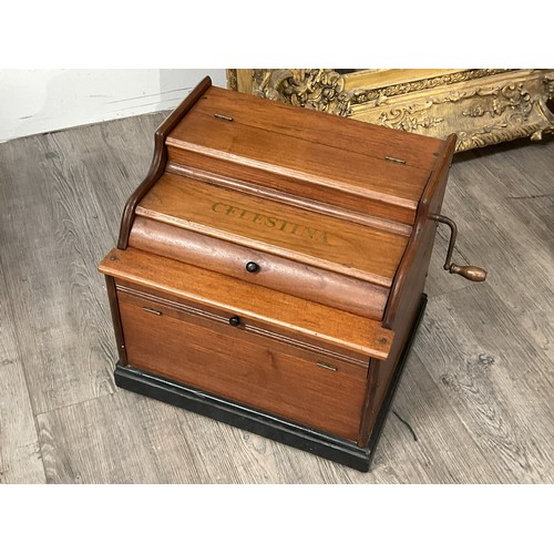 9034 - A circa 1900-1910 American Celestina tabletop organette, walnut cased with two rolls of music, who u... 