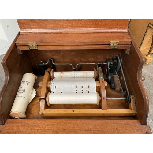 9034 - A circa 1900-1910 American Celestina tabletop organette, walnut cased with two rolls of music, who u... 