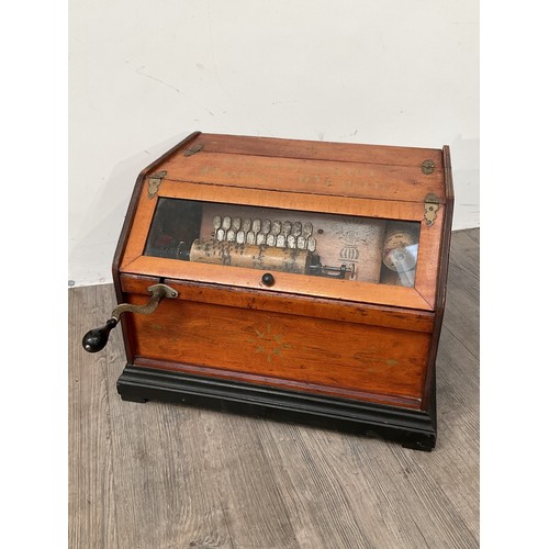 9035 - A circa 1890 American 22 note tabletop roller organ with four rolls, pine cased with bromides plinth... 