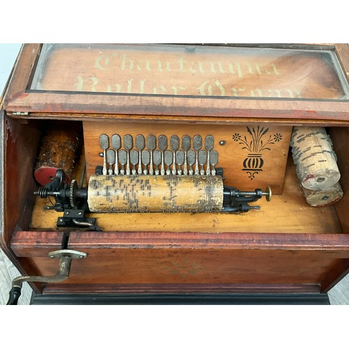 9035 - A circa 1890 American 22 note tabletop roller organ with four rolls, pine cased with bromides plinth... 