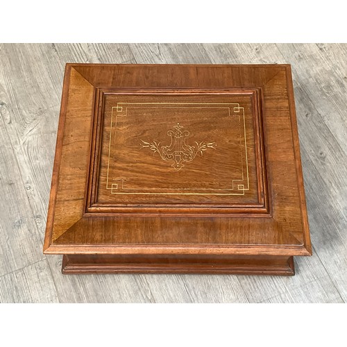 9036 - A tabletop Polyphon, 15.5” disc type, walnut case with incised lyre and foliate design, the lid open... 