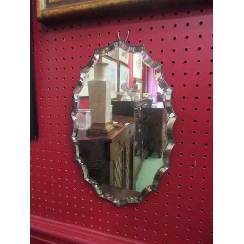 4047A - A Victorian shaped wall mirror with faceted edge, 31cm x 20cm