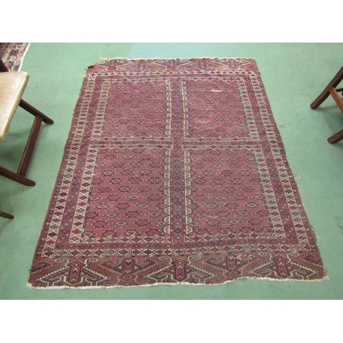 4117 - An Eastern red ground rug with geometric design, a/f, 180cm x 145cm