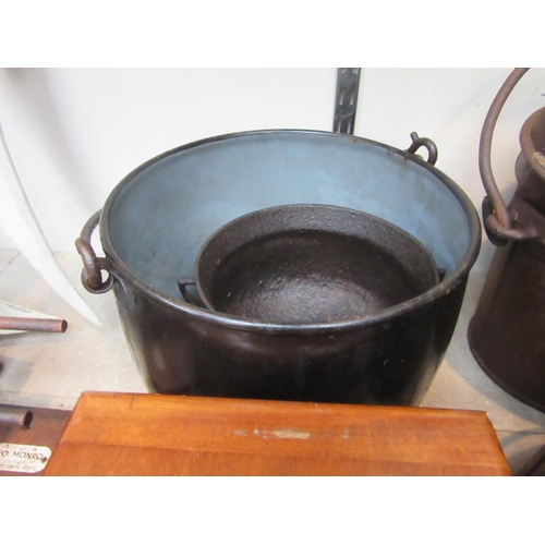 8107 - A cast iron three footed cauldron and enamel pot