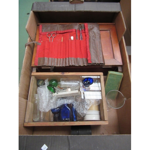 8183 - A box containing First Aid case, coloured glass eye baths, measuring glass etc