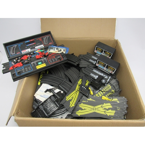 1580 - A large box of Tyco slot racing track, car spares, race computer, lap counters, hand throttles etc.