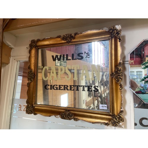 8374 - A gilt framed hanging mirror with later painted Wills Capstan Cigarettes lettering to glass