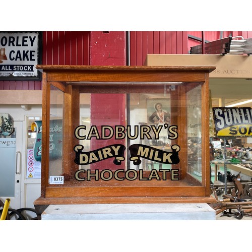 8375 - A glazed cabinet with later Cadburys Dairy Milk Chocolate lettering added