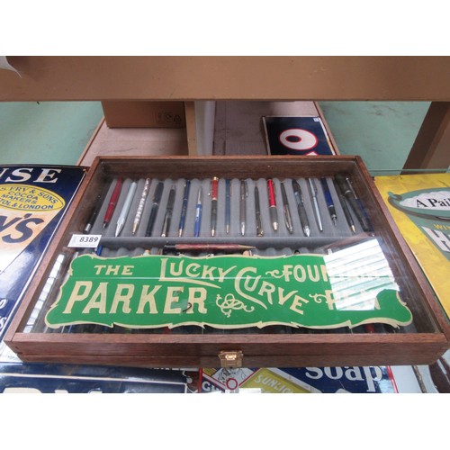 8389 - A table top display cabinet with later painted 'Parker Pens' lettering to top containing a quantity ... 