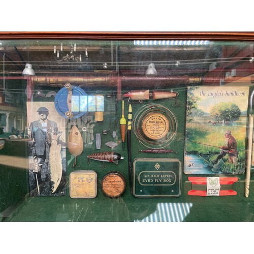 8231 - A glazed display cabinet containing fishing related items; split cane rod, books, lures etc