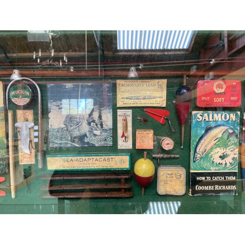 8231 - A glazed display cabinet containing fishing related items; split cane rod, books, lures etc