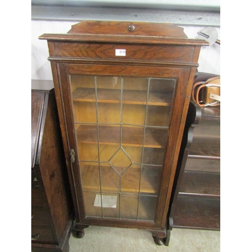 2111 - A 1930's oak and lead-glazed bookcase, door a/f