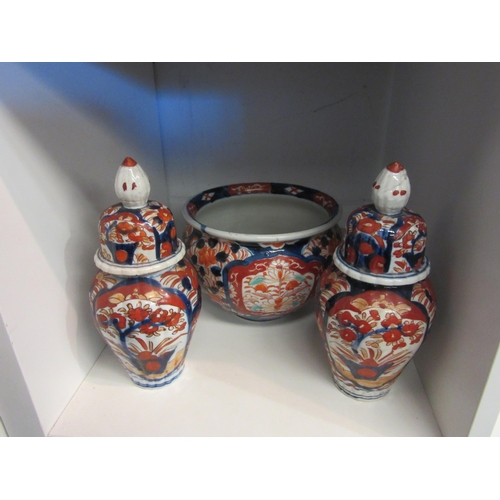 1507 - A pair of export Imari pallette ginger jars together with a similar jardiniere (3)