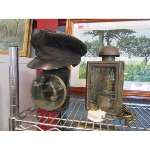 1519 - A railway signal lamp marked B.R., a 1962 Luton railway cap and a carriage lamp (3)