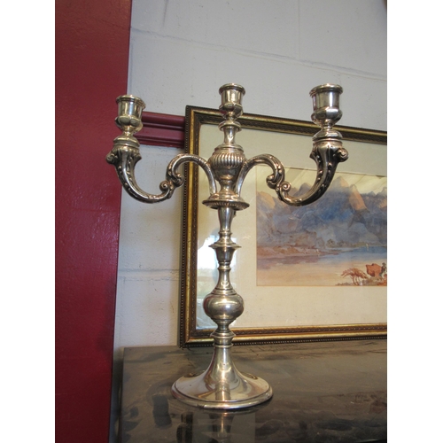 1551 - A silver plated three branch candelabra, one loose, 35cm tall