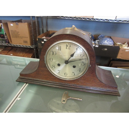 1591 - An oak mantel clock with key and pendulum