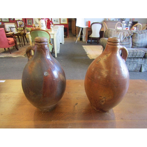 1004 - Two late 18th/early 19th Century stoneware flagons, 37cm tall