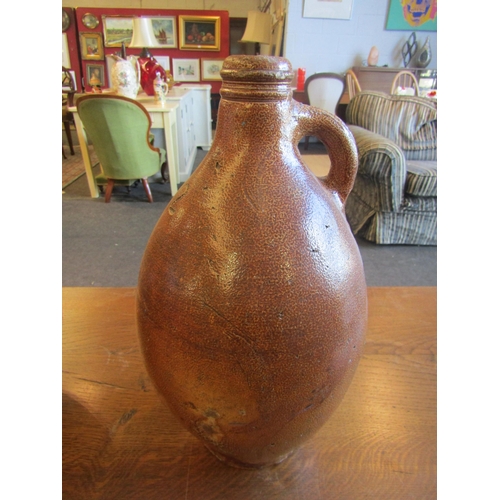 1004 - Two late 18th/early 19th Century stoneware flagons, 37cm tall