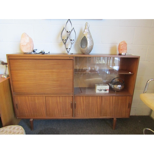 1021 - A mid-20th Century sideboard with adjustable shelving and partitioned drop front cupboard, 107cm hig... 