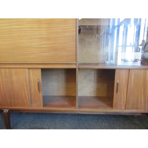 1021 - A mid-20th Century sideboard with adjustable shelving and partitioned drop front cupboard, 107cm hig... 