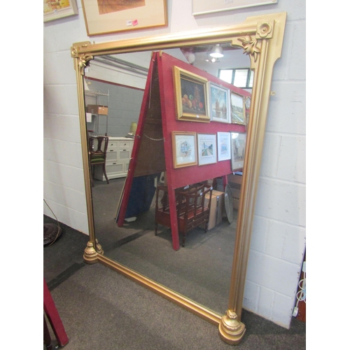 1034 - A large gilt sprayed Victorian overmantel mirror with floral embellishment, 164cm x 136cm