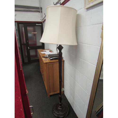 1037 - A mahogany standard lamp with shade