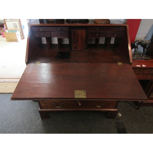 1102 - A 19th Century mahogany bureau, drop-flap with fitted interior, four graduating long drawers on brac... 