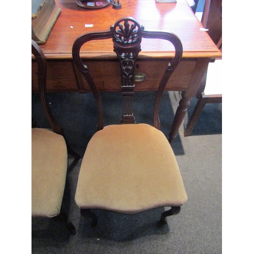 1110 - A pair of mahogany William IV hall chairs with carved back rests