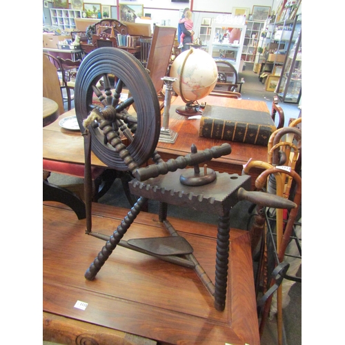 1114 - An oak bobbin-turned spinning wheel and an oak height adjustable stool on tripod legs