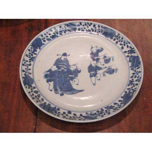 1120 - A pair of early 20th Century Chinese blue and white ceramic plates with figural scenes, floral borde... 