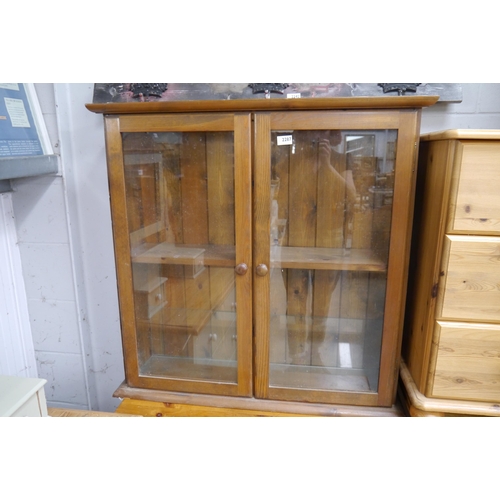 2285 - A pine and glazed two door bookcase