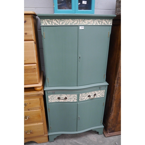 2300 - A green painted mahogany drinks cabinet with mirror and glass shelved interior