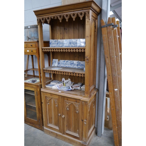 2309 - A reproduction Gothic pine bookcase, one side cut