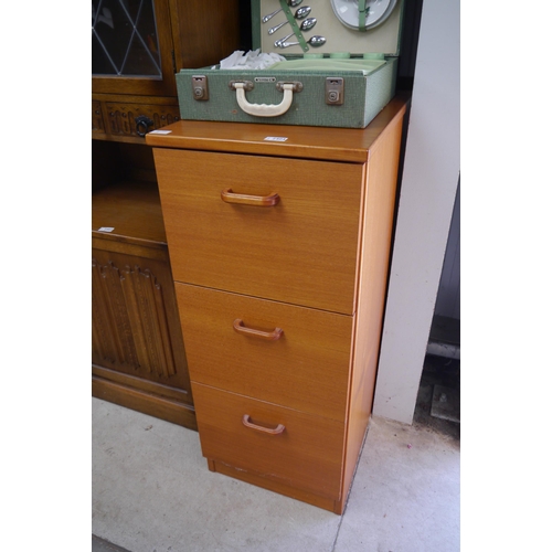 2444 - A teak three drawer filing cabinet and files