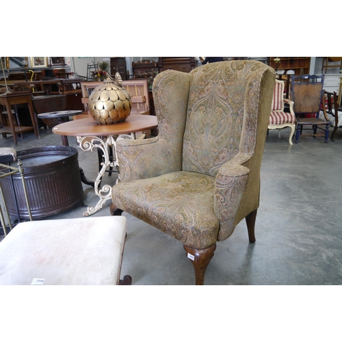 2007 - A Georgian wingback armchair on oak cabriole legs