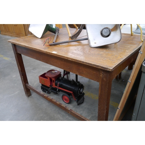 2053 - An Edwardian solid oak school desk , with central partition grove to centre, under slats missing