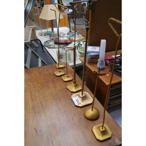 2065 - Seven brass hat stands