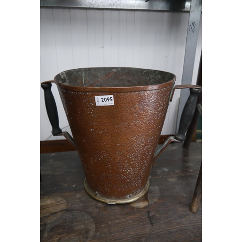 2095 - A 19th Century worked copper twin handle bucket