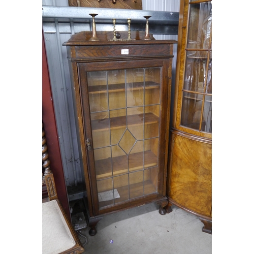 2111 - A 1930's oak and lead-glazed bookcase, door a/f