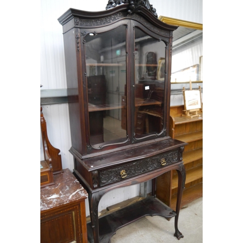 2150 - A Victorian carved and ebonised mahogany cabinet on stand with central drawer