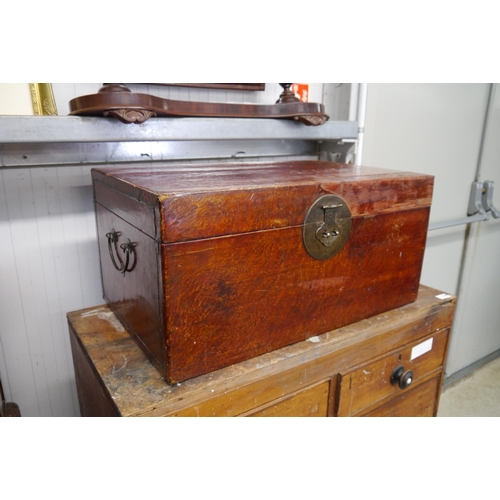 2164 - An Oriental leather covered box with colour patch repair