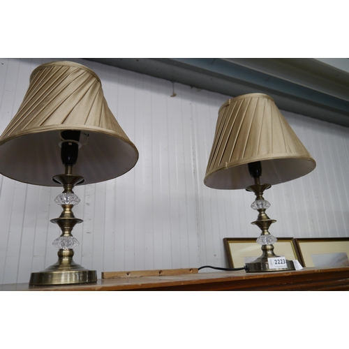 2223 - A pair of glass and brass effect metal table lamps, with pleated shades