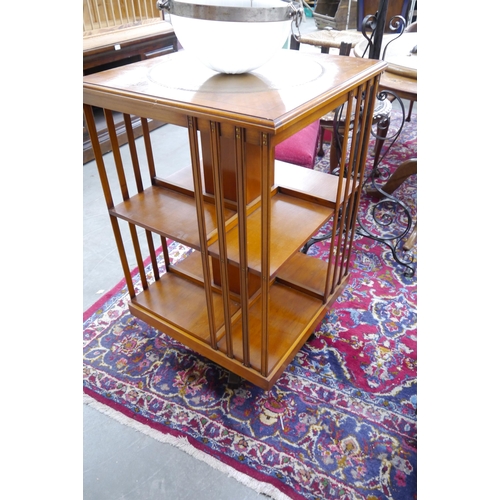 2258 - A yew wood revolving bookcase with leather insert top