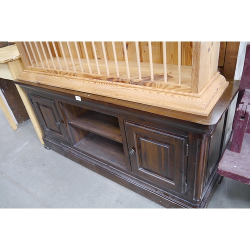 2263 - A stained pine TV stand with two cupboards