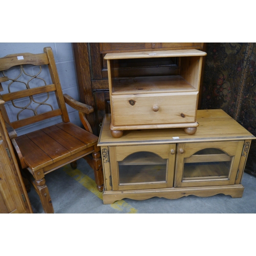 2330 - A pine and glazed two door entertainment unit, pot cupboard and elbow chair