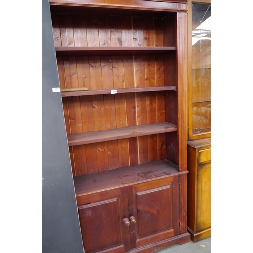 2334 - A pine bookcase over cupboard